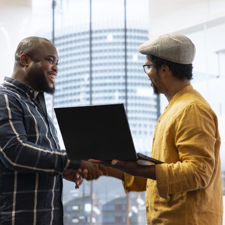 Business owner planning a property investment during office tour with broker, examining the building layout on architectural blueprints and sharing his vision. Office relocation strategy.